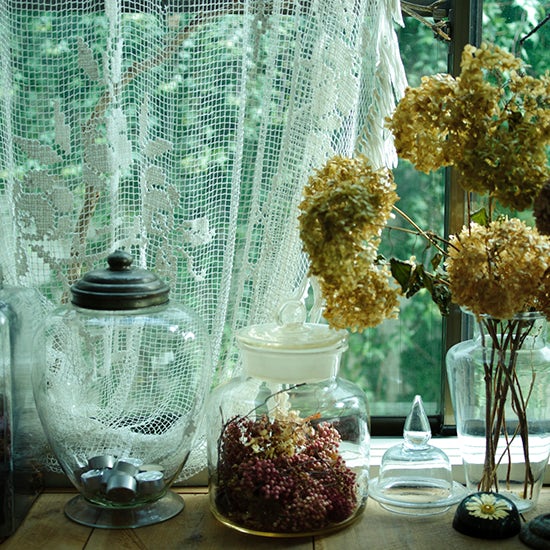 あちこちで見つけた古いガラス瓶には、自宅で飾りながら、自然にドライフラワーになった紫陽花などをディスプレイ